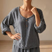 Gray FJØRNA women's summer blouse with V-neck, linen fabric, flowy and breathable for warm weather.