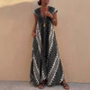 Gray bohemian-inspired flowing A-line maxi dress with deep V-neck and geometric motifs by FJØRNA.