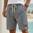 Gray men's casual drawstring shorts with pockets and elegant accents, featuring a relaxed fit and stylish design by FJØRNA.