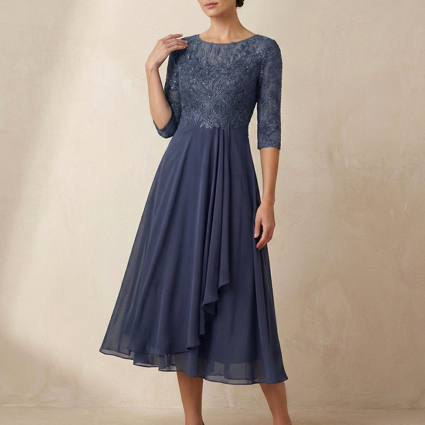 Gray embroidered A-line midi dress with sheer sleeves and pockets by FJØRNA, showcasing detailed embroidery and elegant design.