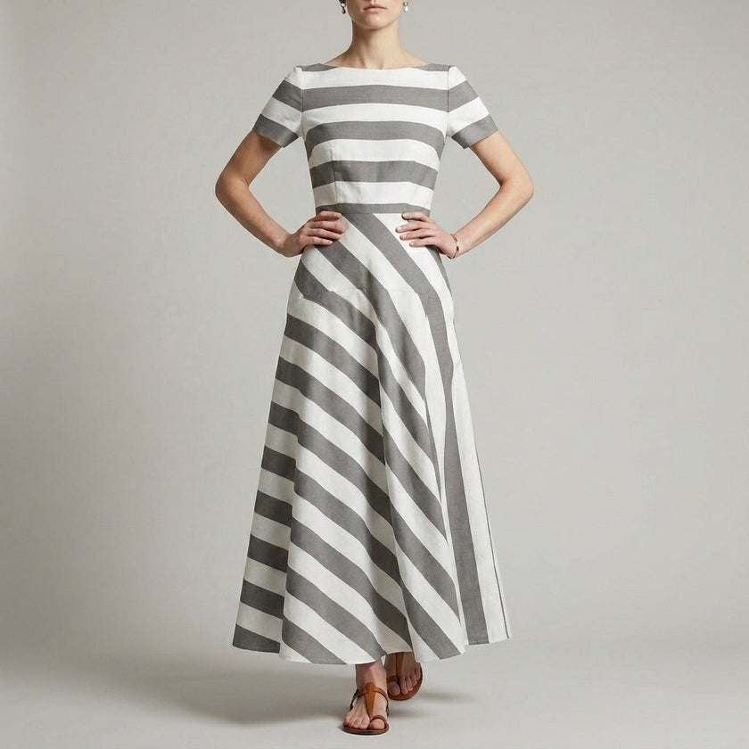 Gray FJØRNA A-line striped maxi dress with pockets, flowing fabric, and a relaxed fit for women.