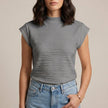 Gray women's summer top by FJØRNA featuring a high neckline and cap sleeves, laid flat to showcase the style and fabric.