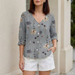 Gray floral V-neck summer blouse for women by FJØRNA, featuring denim fabric and button-front design.