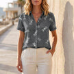 Gray print denim summer blouse for women by FJØRNA, featuring a stylish casual top with a relaxed fit.
