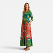 Green and red women's summer maxi dress by FJØRNA with floral pattern, flowing fabric, perfect for warm weather.