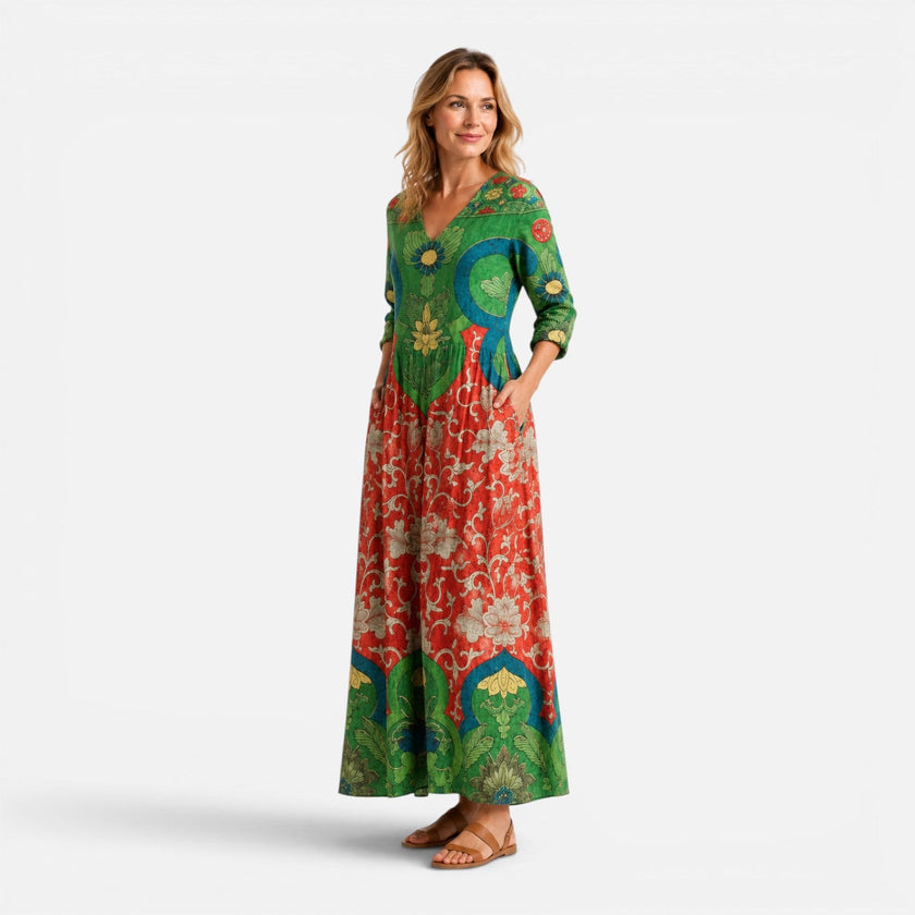 Green and red women's summer maxi dress by FJØRNA with floral pattern, flowing fabric, perfect for warm weather.