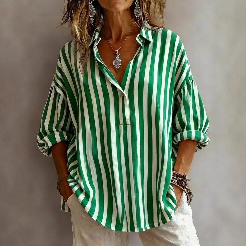 Green FJØRNA women's summer swimsuit with a V-neck and flowy design, perfect for beach and poolside wear.