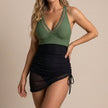 Green and black V-neck women's summer swimsuit by FJØRNA, bodycon fit, stylish swimwear for warm weather.