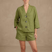 FJØRNA oversized green lounge set with button details, relaxed shorts and matching top, comfortable casual 2-piece outfit.