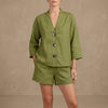 FJØRNA oversized green lounge set with button details, relaxed shorts and matching top, comfortable casual 2-piece outfit.
