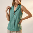 Green sleeveless V-neck blouse for women by FJØRNA with statement button details, stylish top for casual or chic outfits.