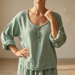 Green FJØRNA women's summer blouse with V-neck, linen fabric, flowy and breathable for warm weather, stylish top for women.