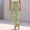 Green linen women's summer trousers with drawstring waist by FJØRNA, lightweight and comfortable for warm weather.