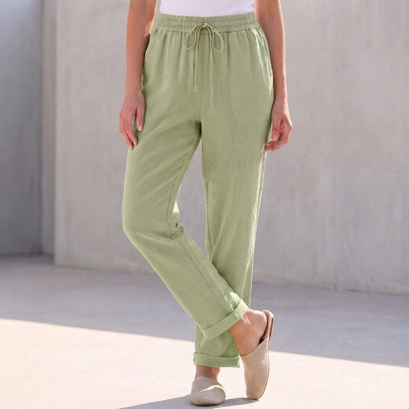 Green linen women's summer trousers with drawstring waist by FJØRNA, lightweight and comfortable for warm weather.
