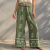 Green women's cotton wide-leg trousers by FJØRNA, relaxed fit with a flowy silhouette for summer wear.
