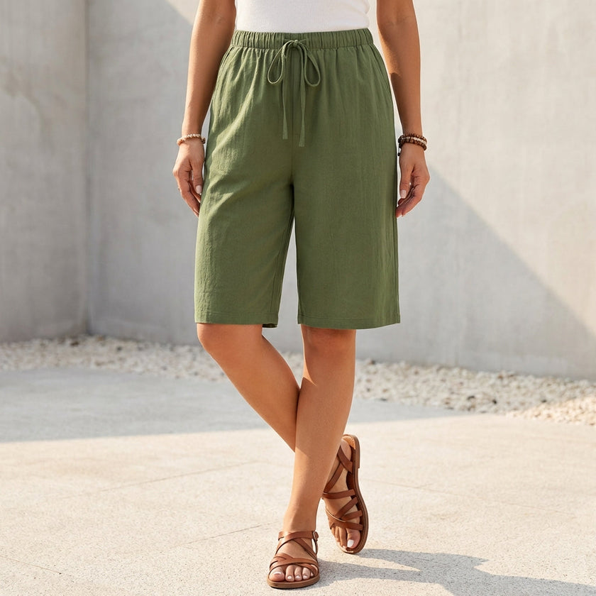 Green women's summer shorts by FJØRNA with cotton fabric and drawstring waist, casual and comfortable for warm weather.