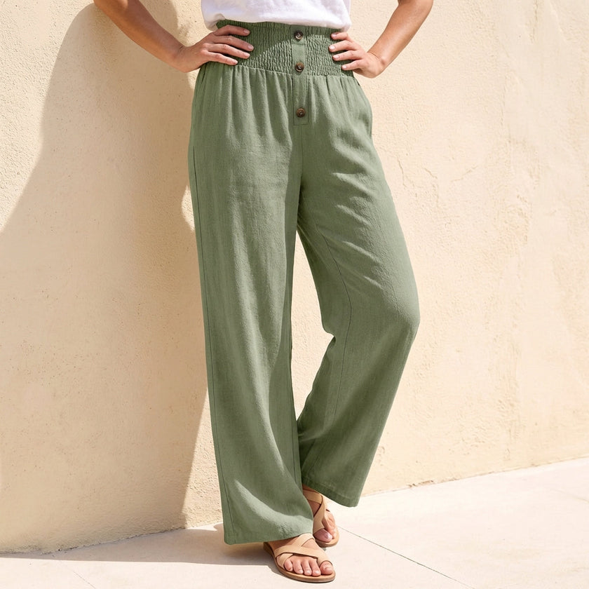 Green women's linen trousers with button front, stylish summer trousers from FJØRNA, perfect for warm weather.