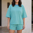 Green FJØRNA relaxed striped lounge set with oversized top and matching shorts, perfect for comfortable casual wear.