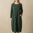Green FJØRNA relaxed knit maxi dress with textured pattern and patch pockets, flowing and comfortable for casual wear.