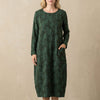 Green FJØRNA relaxed knit maxi dress with textured pattern and patch pockets, flowing and comfortable for casual wear.