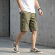 Men's green casual cargo shorts with distinctive stitch detail by FJØRNA, featuring multiple pockets and relaxed fit.