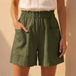 Green linen summer shorts for women with pockets by FJØRNA, casual and comfortable for warm weather.