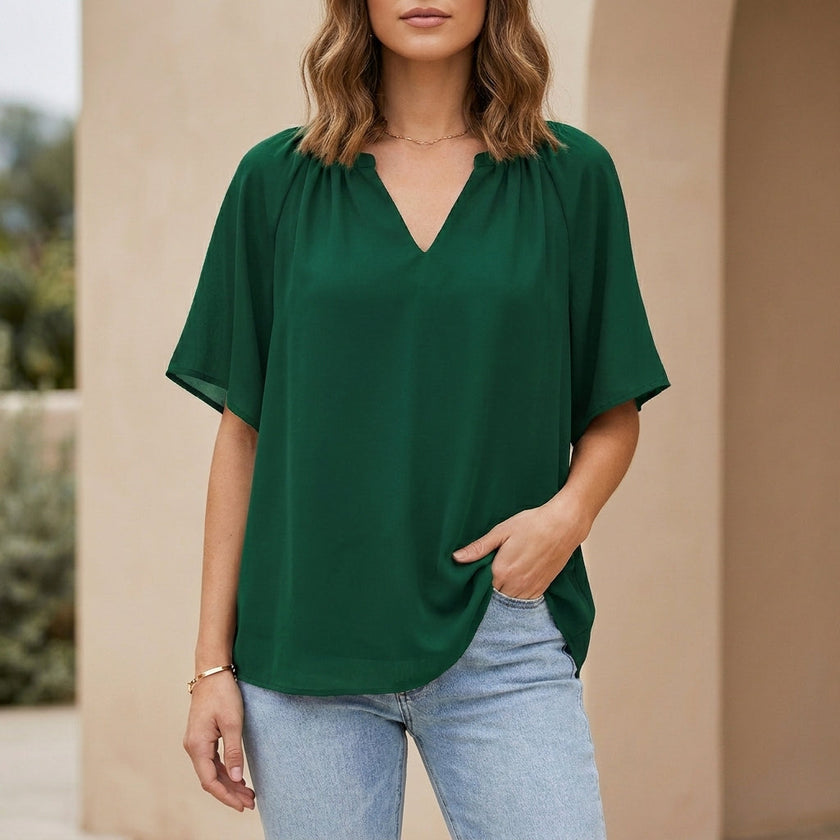 FJØRNA women's green summer blouse with V-neck and flutter sleeves, stylish lightweight top for warm weather.