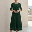 Green FJØRNA A-Line maxi dress with mesh panels and side pockets, flowing midi-length style for women.
