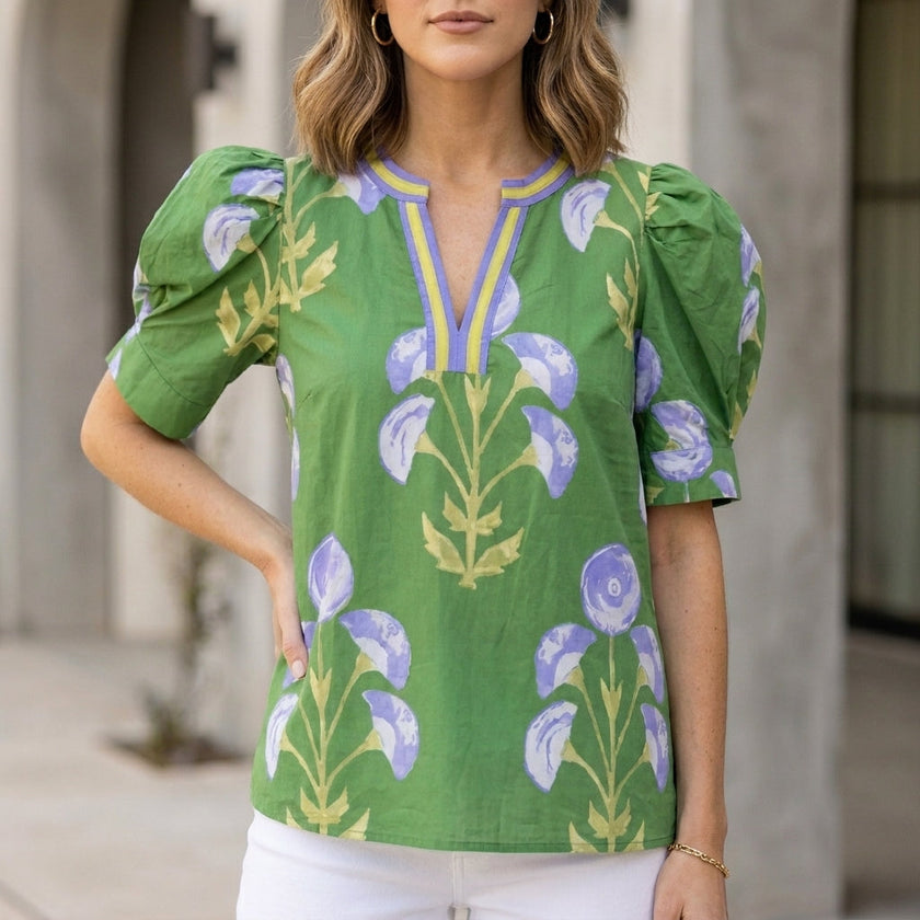 Green floral summer blouse for women with V-neck, puff sleeves, and high waist by FJØRNA, shown on a model.
