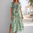 Green FJØRNA Bohemian A-Line scoop neck maxi dress for women, flowing fabric and relaxed fit, displayed on a mannequin.