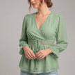 Green FJØRNA summer blouse for women with v-neck and ruffle details, made of linen fabric, stylish and breathable top.