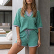 Green knit striped summer two-piece set for women by FJØRNA, featuring a stylish coordinated top and matching bottoms.