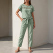 Green FJØRNA women's two-piece co-ord set with mesh pockets, featuring a stylish top and matching pants for casual wear.