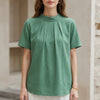 Green FJØRNA summer blouse for women with a high neck and short sleeves, stylish and lightweight top for warm weather.