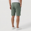 FJØRNA men's green linen shorts with elastic waistband and drawstring, shown from the back, perfect for summer beachwear.