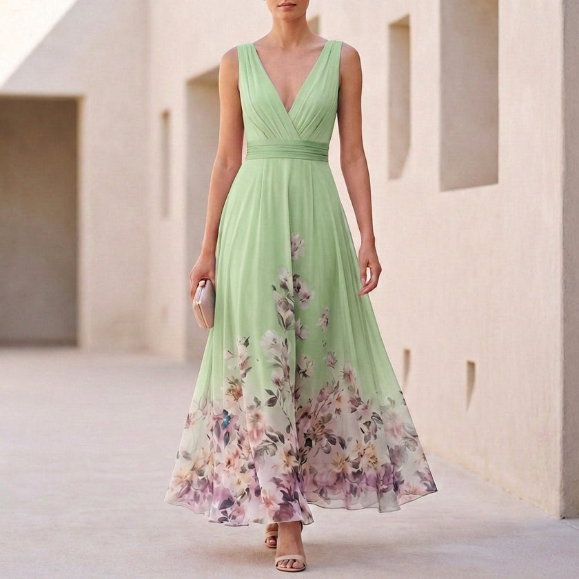 Green floral A-line maxi dress by FJØRNA featuring sleeveless design and V-neck, styled with a flowy, elegant silhouette.