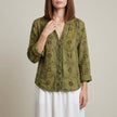 Green floral linen summer blouse for women with V-neck and long sleeves, by FJØRNA, featuring a relaxed fit and lightweight fabric.