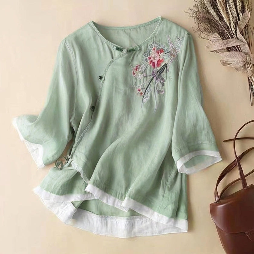 Green floral V-neck linen blouse for women by FJØRNA, featuring lightweight fabric and a relaxed summer style.