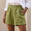 Green linen summer shorts for women with high waist and pockets, relaxed fit from FJØRNA.