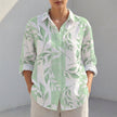 Green FJØRNA women's tunic shirt with V-neck, collared neckline, and roll-tab sleeves, styled as a casual women's top.