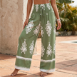 Green summer women's trousers by FJØRNA featuring cotton fabric and a drawstring waist for a casual, comfortable look.