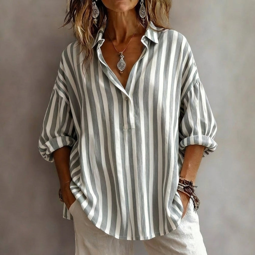 Grey women's summer swimsuit with a V-neck and flowy design by FJØRNA, ideal for beach and poolwear.
