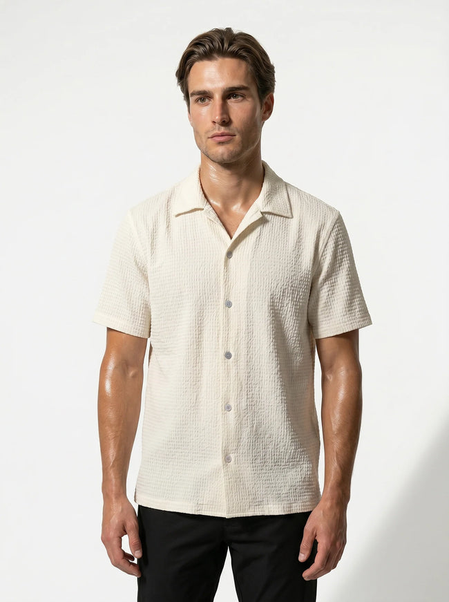 FJØRNA men's short sleeve button-up shirt, casual classic men's top in a relaxed fit, shown in a half-shot focus image.