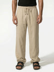Men's linen trousers by FJØRNA, relaxed fit, breathable summer pants shown in a half-shot focusing on fabric and design.