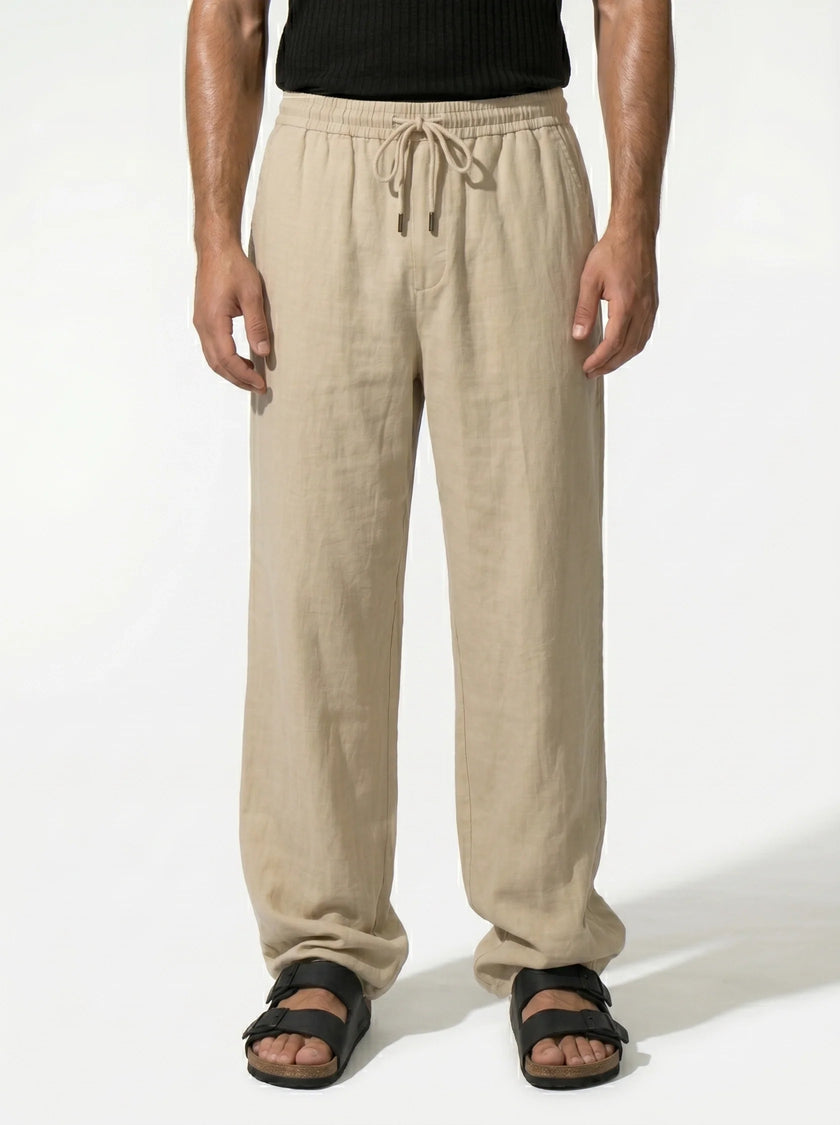 Men's linen trousers by FJØRNA, relaxed fit, breathable summer pants shown in a half-shot focusing on fabric and design.