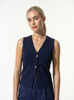 FJØRNA women's sleeveless tailored waistcoat with structured design, layering style, and fitted silhouette for modern office wear.