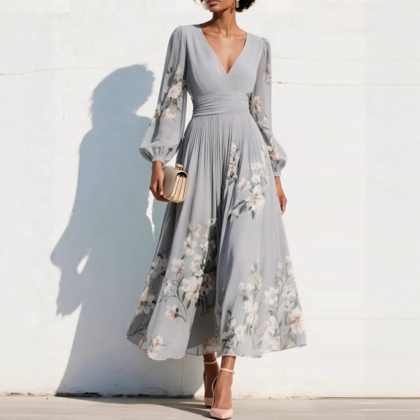 FJØRNA floral print long-sleeved V-neck pleated dress with elegant design, featuring a floral pattern and flowing fabric.