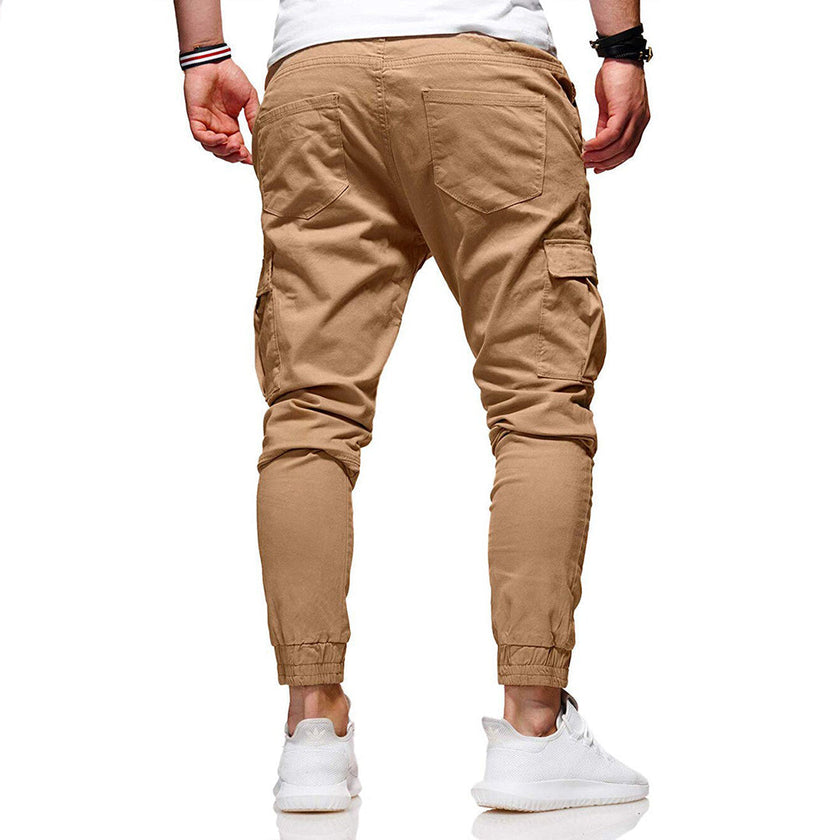 Men's cargo pants by FJØRNA with functional pockets and ample storage, shown in a neutral color, designed for outdoor wear.