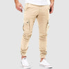 Men's FJØRNA cotton slim fit cargo pants with multiple pockets, shown on a model. Durable, versatile men's pants for casual wear.