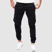 Men's FJØRNA cargo pants in cotton, slim fit style with multiple front and back pockets, designed for comfort and practical wear.